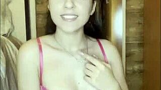 Diabla teases herself with a pink dildo in solo play.