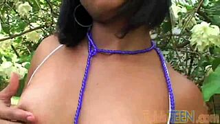 Hey, check out this teen with small tits fingering her wet pussy in the garden!