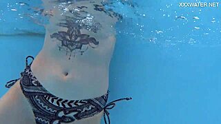 Feeling free as mimi cica swims nude in the pool, her tattoos glistening underwater during passionate sex
