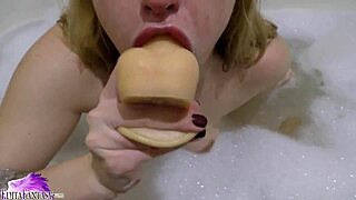 Cute Babe Sloppily Sucks Huge Dildo in Foamy Bath