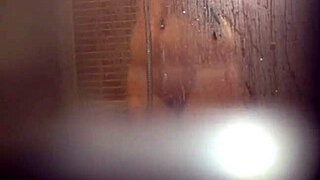 girl caught stroking her wet pussy in the shower stall