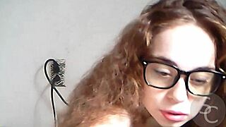 Teen with natural tits goes topless on webcam, playing with pussy and toys in public outdoor setting.