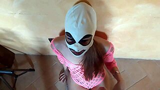 A Latina teen gives a rough POV blowjob dressed in a pink fishnet dress and pink platform shoes