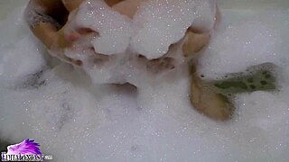 Cute babe sloppy sucks huge dildo in foamy bath