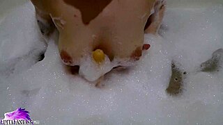 Cute babe sloppy sucks huge dildo in foamy bath
