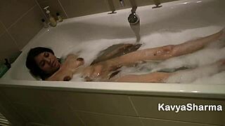 Kavya, this Indian babe with natural boobs, is in the bathtub fingering her tight pussy