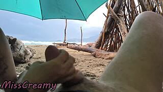 student handjobs cock on stormy beach in public voyeur cumshot