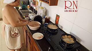 Nudist Housewife Regina Noir Cooks in the Kitchen with Naked Maid Assistance in Chapter One.